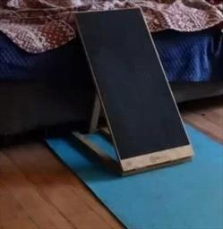 A nail board angled against a couch
