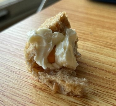 A butter-covered capsule wrapped in bread